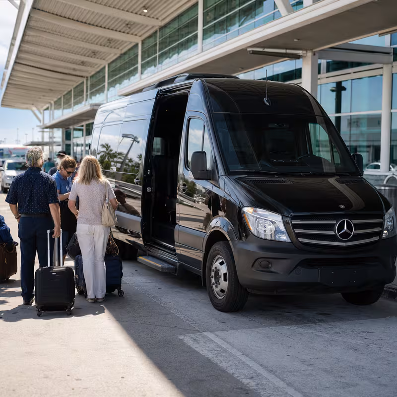 Group boarding a white charter bus for Airport Transportation transportation in Fort Myers