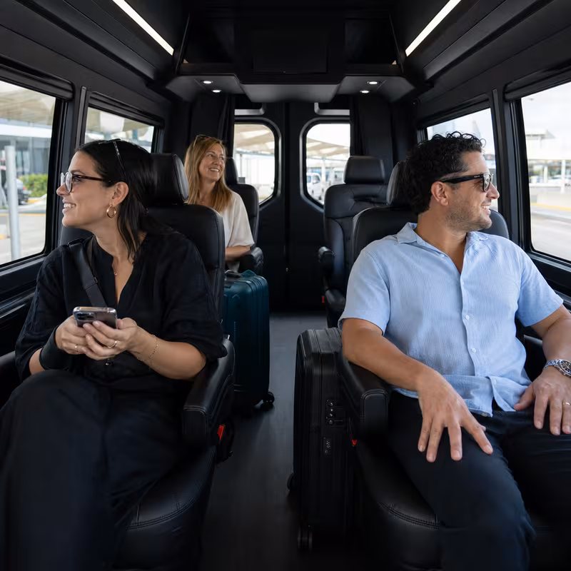 Passengers loading luggage while boarding an Fort Myers group shuttle