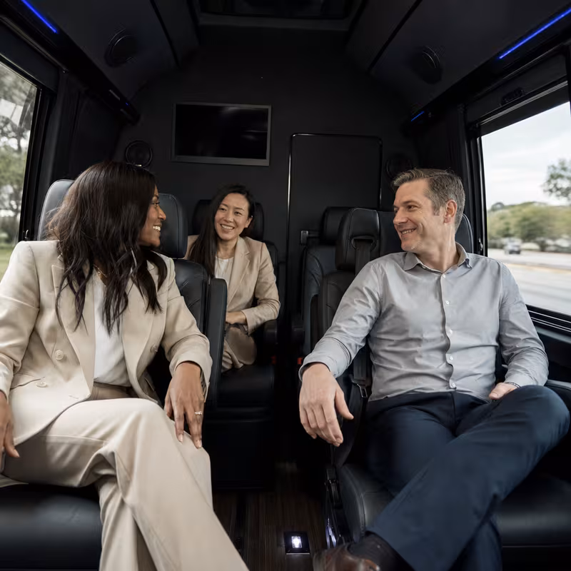 Group boarding a white charter bus for Corporate Transportation transportation in Fort Myers