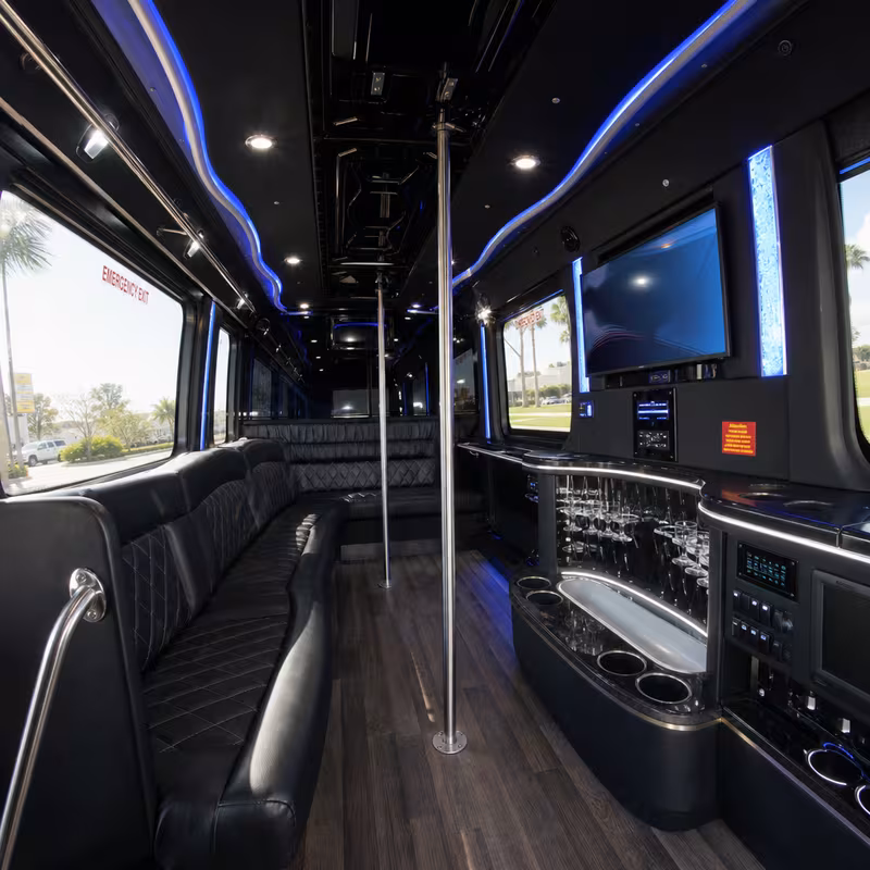 Party bus interior with wraparound leather seating and LED lighting in Fort Myers