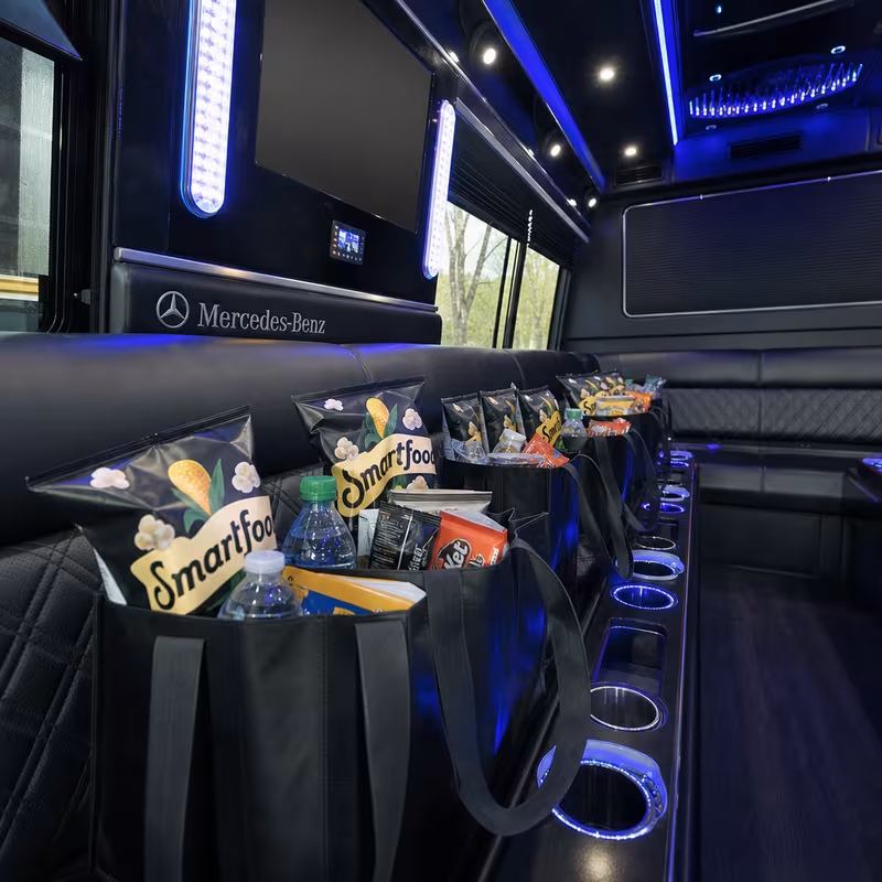 Party bus interior with wraparound leather seating and LED lighting in Fort Myers
